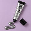 Silver drop gel squeezing out of black tube